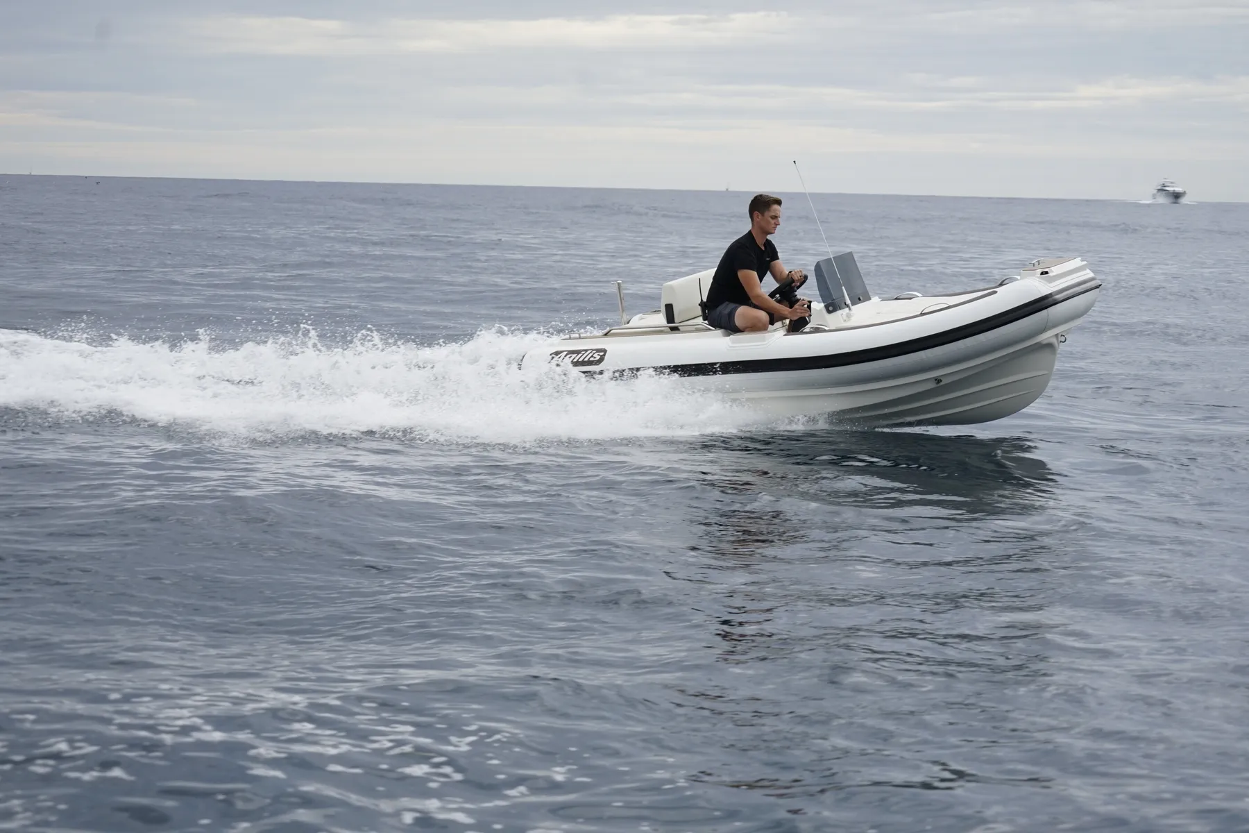 Agilis jet tender at speed on open water, jet-drive wake behind